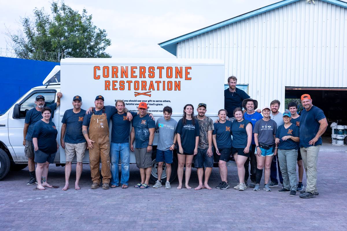 Cornerstone Restoration volunteer team photographed in front of their truck